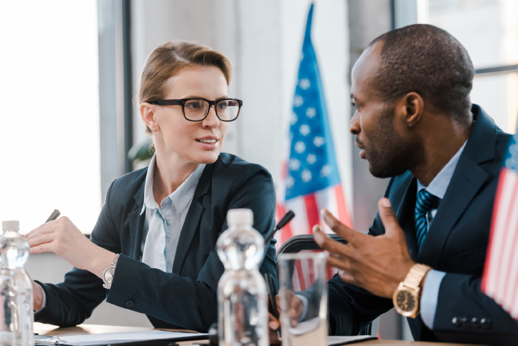 selective focus of diplomat talking with african american representative