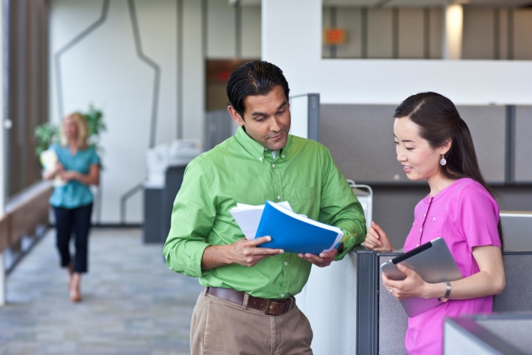 happy man showing woman printed documents