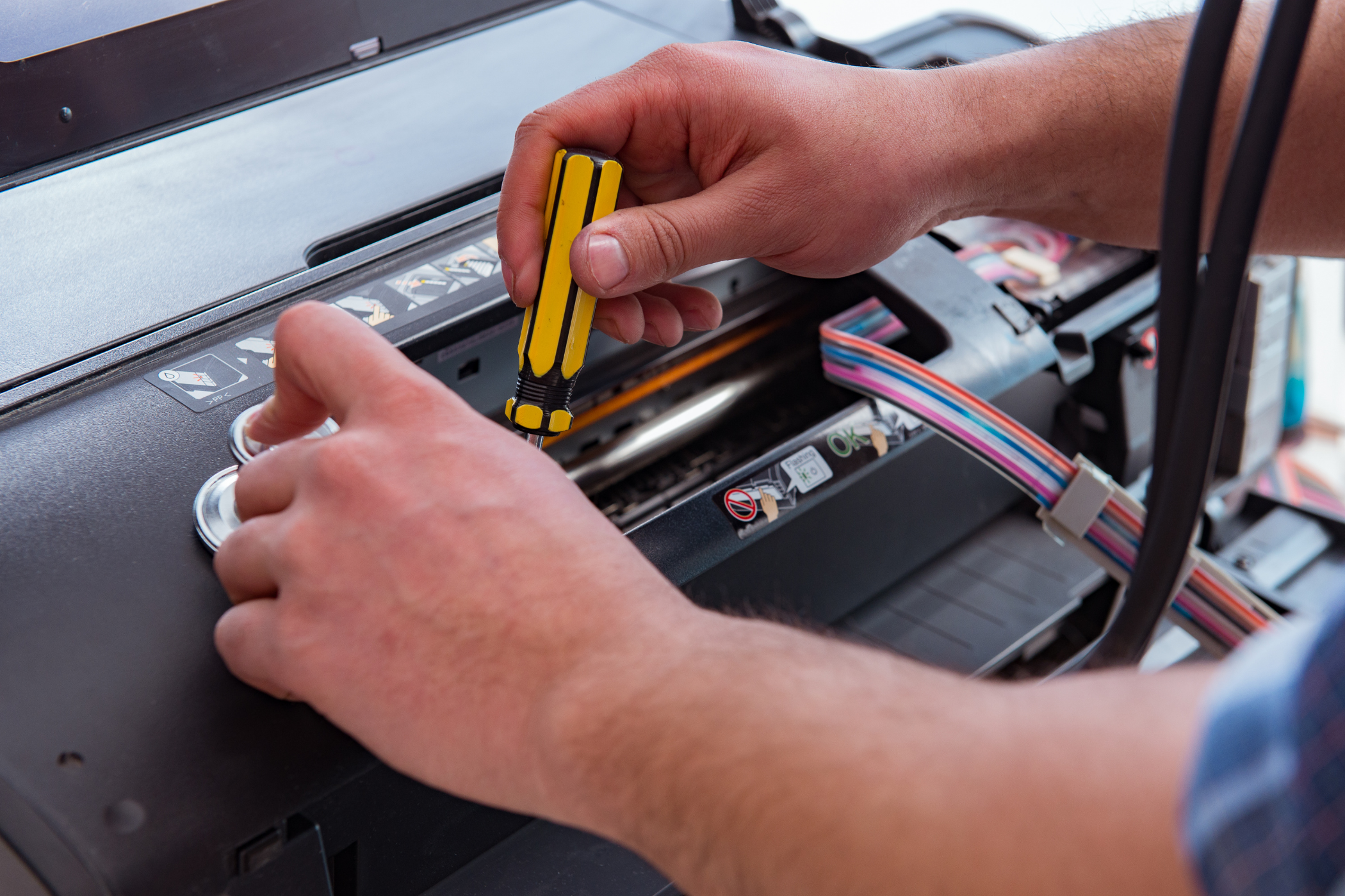 technician fixing an office printer