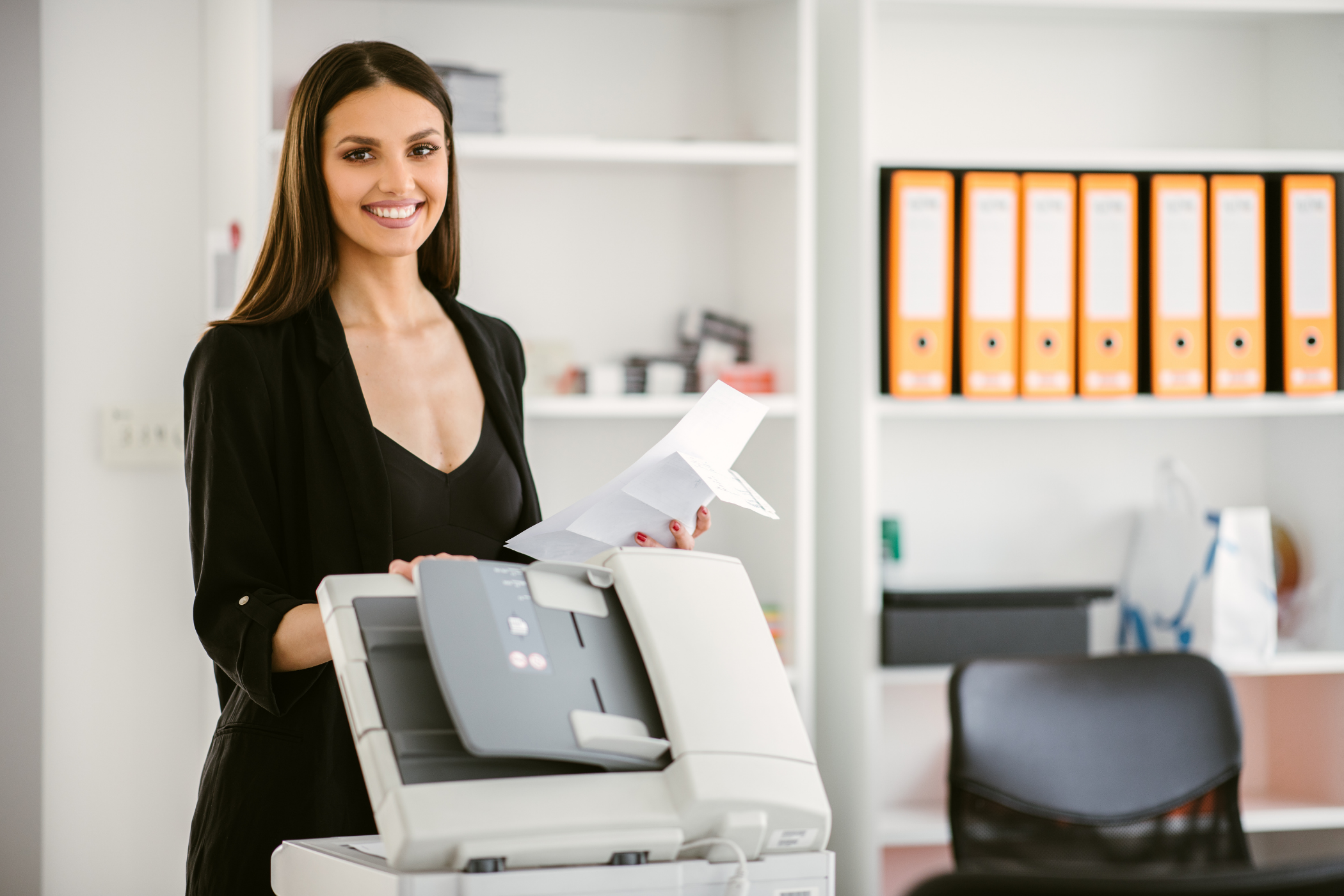 happy women in front of a laser printer